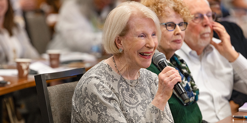 An older woman asks a question during the event