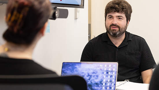 Male researcher talking to female researcher