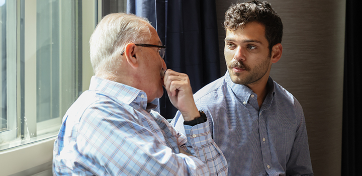 Photo of male student talking to older man